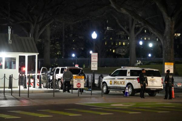 U.S. Secret Service police investigate near a vehicle that hit a security barrier at a entry point for the White House complex 