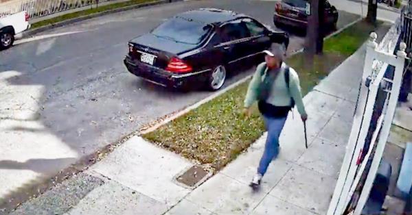 A man carrying what appears to be a rod or a pipe is seen on a surveillance video following a woman pushing a baby in a stroller