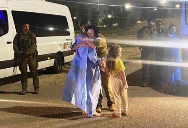 newly-released hostages hug