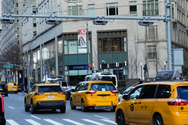 Cars pass below recently installed electro<em></em>nic toll scanners along Broadway near Columbus Circle, Thursday, Jan. 4, 2024, in New York. (AP Photo/Frank Franklin II)