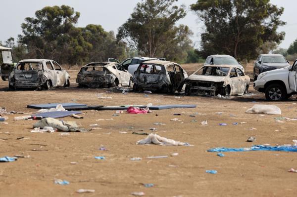 Burnt cars are left behind at the site of the weekend attack on the Supernova desert music Festival by Palestinian militants, near Kibbutz Reim in the Negev desert.