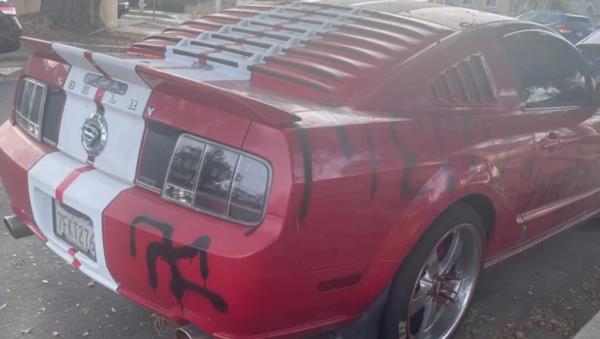 Reginald Scott's Ford Mustang is seen vandalized with swastikas in the middle of San Pedro, California