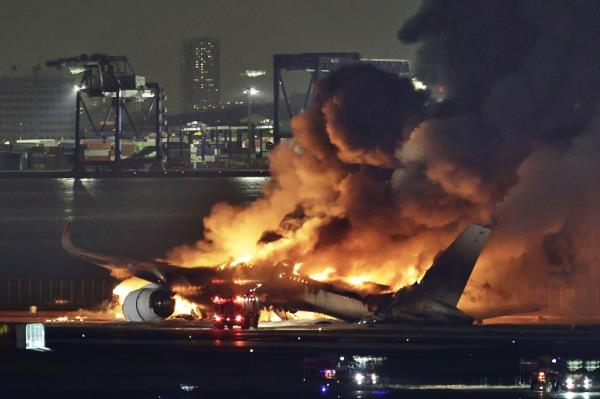 A Japan Airlines plane is on fire on the runway of Haneda airport on Tuesday.