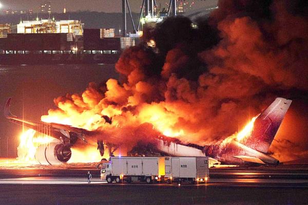 TOPSHOT - This photo provided by Jiji Press shows a Japan Airlines plane on fire on a runway of Tokyo's Haneda Airport on January 2, 2024. 