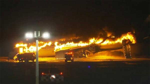 In this image made from video, a Japan Airlines plane is on fire on the runway of Haneda airport on Tuesday, Jan. 2, 2024 in Tokyo, Japan. (NTV via AP)