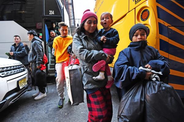 A new bus load of migrants arrive at the Roosevelt Hotel 