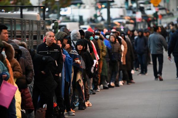 Migrants line up for immigration services outside Federal Plaza in lower Manhattan. 