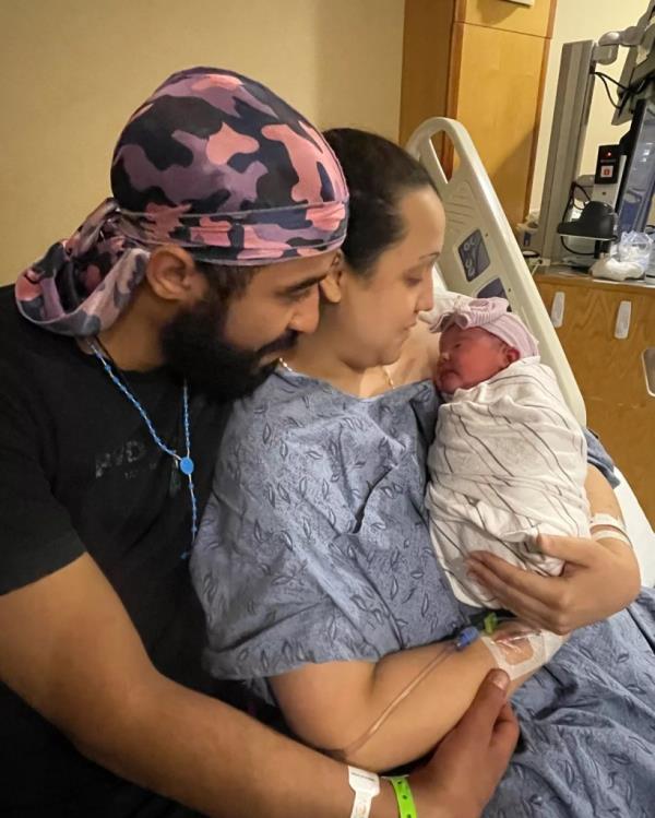 Margarita and Roberto holding their baby. 