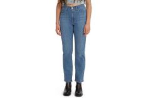 A woman in a pair of blue jeans and boots.