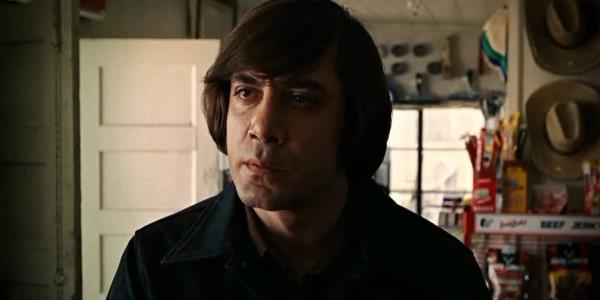 Anton Chigurh (Javier Bardem) stares with intensity in No Country for Old Men.